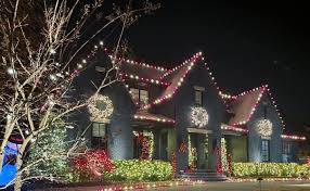 Holiday lighting on large Connecticut home with wraparound porch